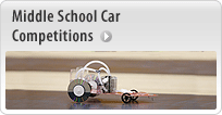A photo of an angular model car on a race track. Words above the car read: Middle School Car Competitions.
