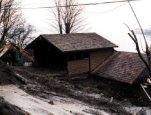 House in the Magnolia Bluffs area overlooking Puget Sound that was struck by a rapidly-moving landslide. The flow deposited material in the garage (upper level) and collapsed the front wall of the liv