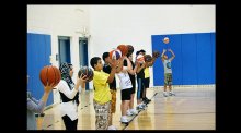 The participants practice ball skills with Brett Issacson of One-on-One Basketball.