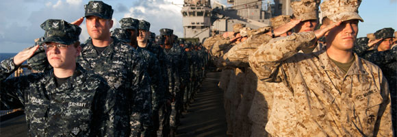 Sailors and Marines saluting on a ship