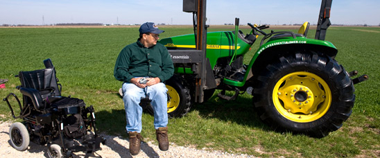 NIFA's AgrAbilty Project recipient uses modified lift to transfer from wheelchair to tractor. Photo credit: National AgrAbility Project at Purdue University.