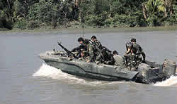 Servicemen in a boat on an inland waterway of Vietnam