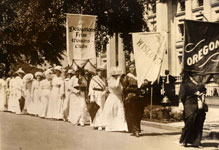 Women carrying signs in a suffrage parade