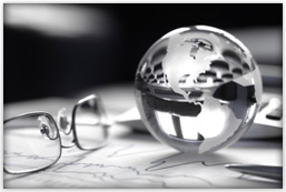 A glass globe rests above data charts.