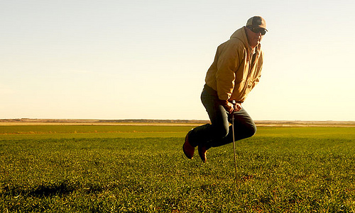 Even though he is putting his entire weight on it, Henderson’s soil pressure probe cannot penetrate the surface of the soil under his neighbor’s dryland wheat crop, which has been farmed with conventional plowing methods.