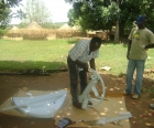 Peter Byengoma at work on satellite installation for Radio Maridi.