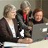 Three Women Around a Computer