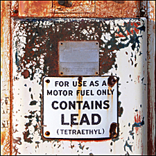 Tank with a sign: USE AS A MOTOR FUEL ONLY - CONTAINS LEAD (TETRAETHYL)