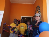Debra Messing, Actress and PSI Global Health Ambassador, cuts the ribbon at a US-funded New Start HIV counseling and testing center in Mongu, Zambia. Photo Credit: Zoeann Murphy