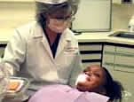 Image of a dental hygienist examining a patient