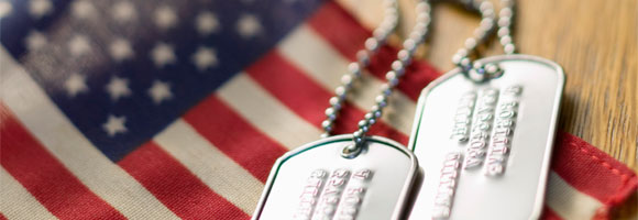 Two dog tags and an American flag