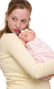 Photograph of a teen mother holding her baby.