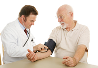 Provider taking a man's blood pressure, since high blood pressure is the leading risk factor for stroke 