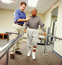 A physical therapist is working with a man in rehabilitation