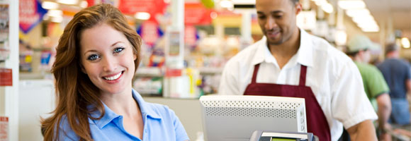 Shopper and cashier at a checkout counter