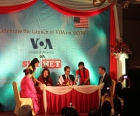 VOA Director David Ensor and Myint Myint Win, Managing Director of Sky Net, sign the agreement. 