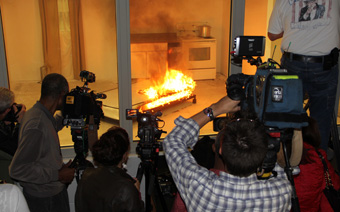 Camera crews shooting a mattress fire at a CPSC press event on fire safety.