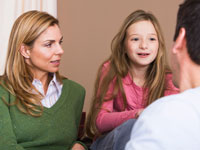 Mother and daughter talking to a doctor.