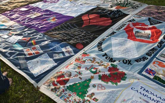 Photo of a section of the AIDS Memorial Quilt laid out on the ground.