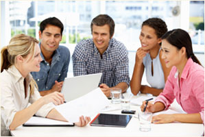 Photograph of a group of people brainstorming at a table.