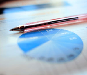 Image of a pie chart printed on a piece of paper, with a pen resting on the paper.