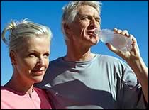 Photo of elderly couple drinking water.