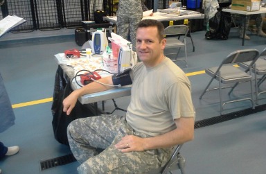 Lt. Col. Christopher Robertson, commander of the 266th Quartermaster Battalion, donates blood to the Armed Services Blood Program.