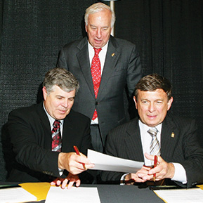 Photo shows Robert Wiltrout, Ph.D., and Melvin Bernstein, Ph.D., signing a formal Memorandum of Understanding.