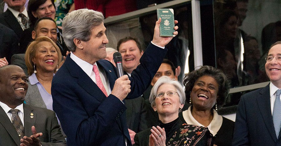 U.S. Secretary of State John Kerry displays his first diplomatic passport, while delivering welcome remarks to U.S. Department of State employees in Washington, D.C., February 4, 2013.  Secretary Kerry was issued the passport while his father served as a U.S. diplomat in Germany; Kerry’s first stamp in it was 1954 in Le Havre. [State Department photo/ Public Domain]
