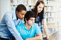 Teens view a computer screen