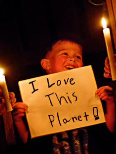 boy with sign for Earth Hour