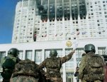 During the storming of the White House, home of Russia's legislature, soldiers from the elite 'Alpha' unit are sent in to conduct negotiations. Vladimir Filonov, photographer. Copyprint, original t