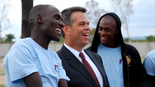 Ambassador Bruce Wharton shares a laugh with Zimkids Director Tinashe Basa in Zimbabwe, December 11, 2012.  [U.S. Embassy photo/ Public Domain]