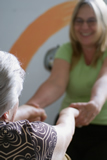 A younger woman is helping an older woman up