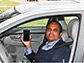 Photo of researcher Ram Dantu holding smart phone in his car.