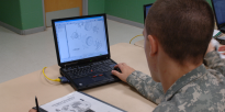 Army mechanic training with computer