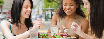 Photo: Three women eating salads