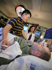 Jessica Mast, R.N., assists during an ultrasound performed by Zhaohui Gao, Ph.D., on study volunteer Josh Miller for one of many cardiac research studies at Penn State Hershey.