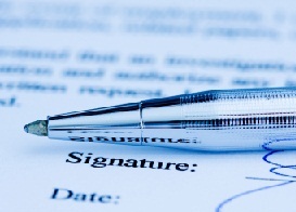 Image of pen on top of printed document with signature.