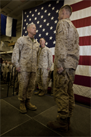 Sergeant Royce R. Hughie (right), team leader, Scout Sniper Platoon, Battalion Landing Team 3/5, 15th Marine Expeditionary Unit, reports to Gen. James F. Amos, Commandant of the Marine Corps, before being awarded the Bronze Star with the “V” combat distinguishing device in the hangar bay of the USS Peleliu, Dec. 28. Hughie received the award for his actions during 3/5’s last deployment to Sangin Province, Afghanistan from 2010-2011. The CMC visited the ship to show support to the Marines and sailors of the 15th MEU and Peleliu Amphibious Ready Group during the holidays. The 15th MEU is deployed as part of the Peleliu ARG as a U.S. Central Command theater reserve force, providing support for maritime security operations and theater security cooperation efforts in the U.S. 5th Fleet area of responsibility. Hughie, 24, is from Springfield, Mo. (U.S. Marine Corps photo by Cpl. John Robbart III)