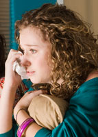 Girl with curly hair crying.