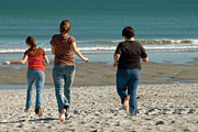 Image of teenagers running on the beach