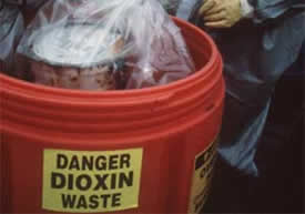 Red container labeled 'DANGER DIOXIN WASTE'