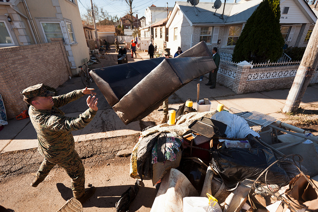 Image description: U.S. Marine Corps Cpl. Thomas Cavallo throws a couch on a pile in Staten Island. Marines and sailors with the 26th Marine Expeditionary Unit worked to support Hurricane Sandy disaster relief efforts in New York and New Jersey.
Hurricane Sandy formed in the western Caribbean Sea and affected Jamaica, Cuba, Haiti and the Bahamas before making landfall in the mid-Atlantic region of the United States.
Photo by Cpl. Bryan Nygaard, U.S. Marine Corps.