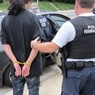 Man being arrested by immigration enforcement.