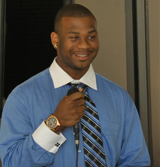 Lawrence Anderson speaking into a microphone