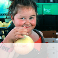 A young girl holding an onion