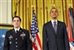 President Barack Obama, right, and former Army Staff Sgt. Clinton L. Romesha stand at attention for the reading of the Medal of Honor citation at the White House in Washington, D.C., Feb. 11, 2013.  U.S. Army photo by Leroy Council