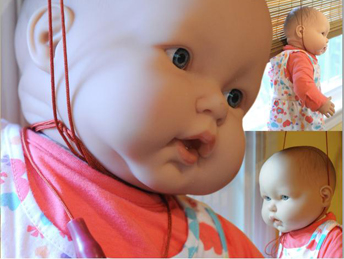 Picture of baby doll with a cord around its neck
