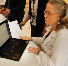 Ann Peterson behind a computer.